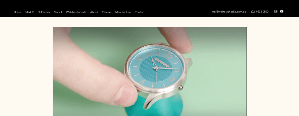 Person holding elegant watch with blue dial.